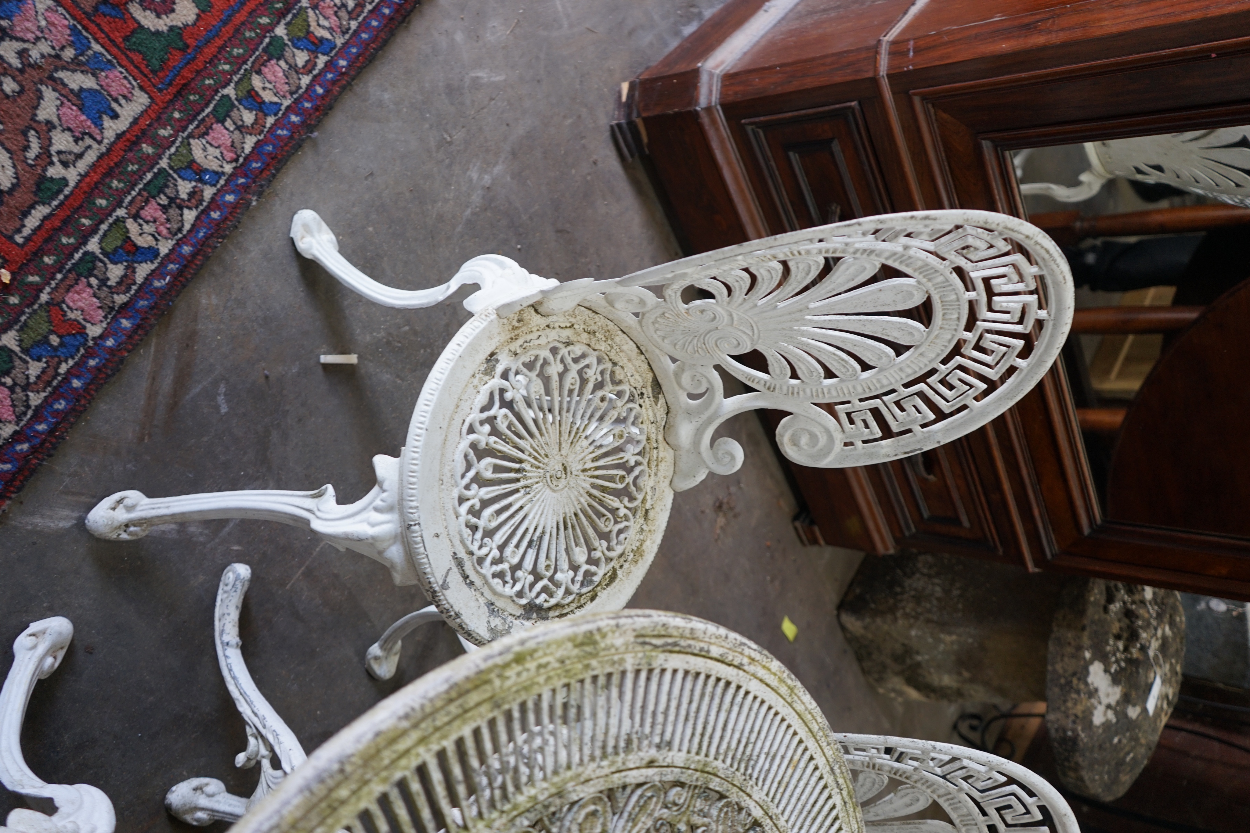 A Victorian style painted aluminium garden table and four chairs, table diameter 80cm height 69cm